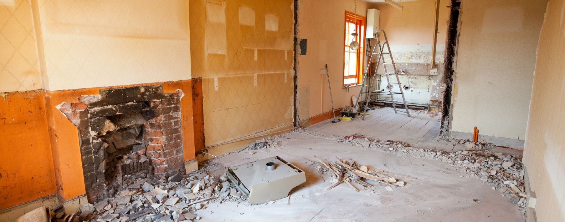 Image of a home during repairs with a fireplace and a ladder