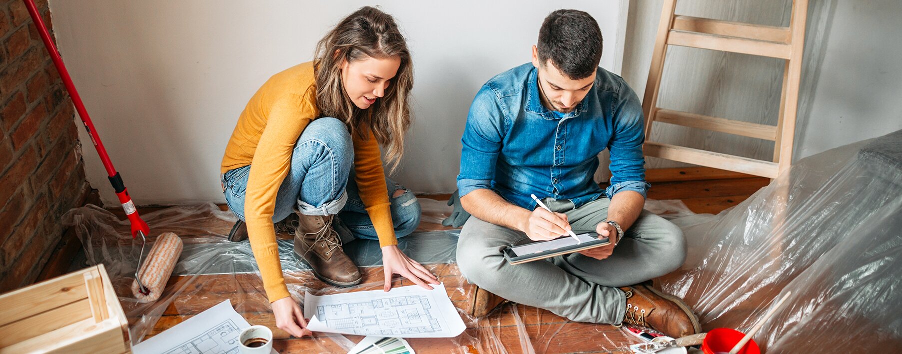 man and woman repairing home after damage