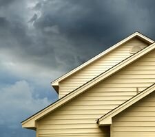 A storm coming in behind a yellow home