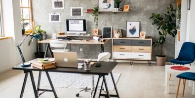 An light colored office with two desks with computers on them